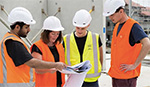 Group of construction students discussing plans with supervisor